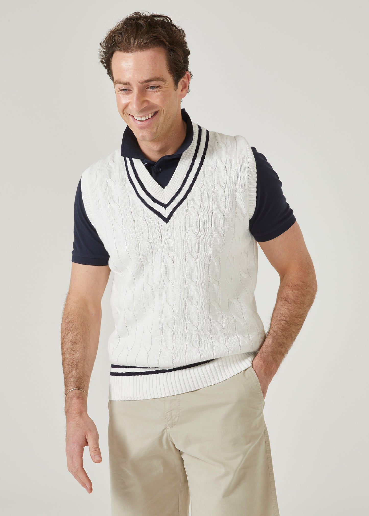 Cable knit slipover with an ecru base and dark navy trim.
