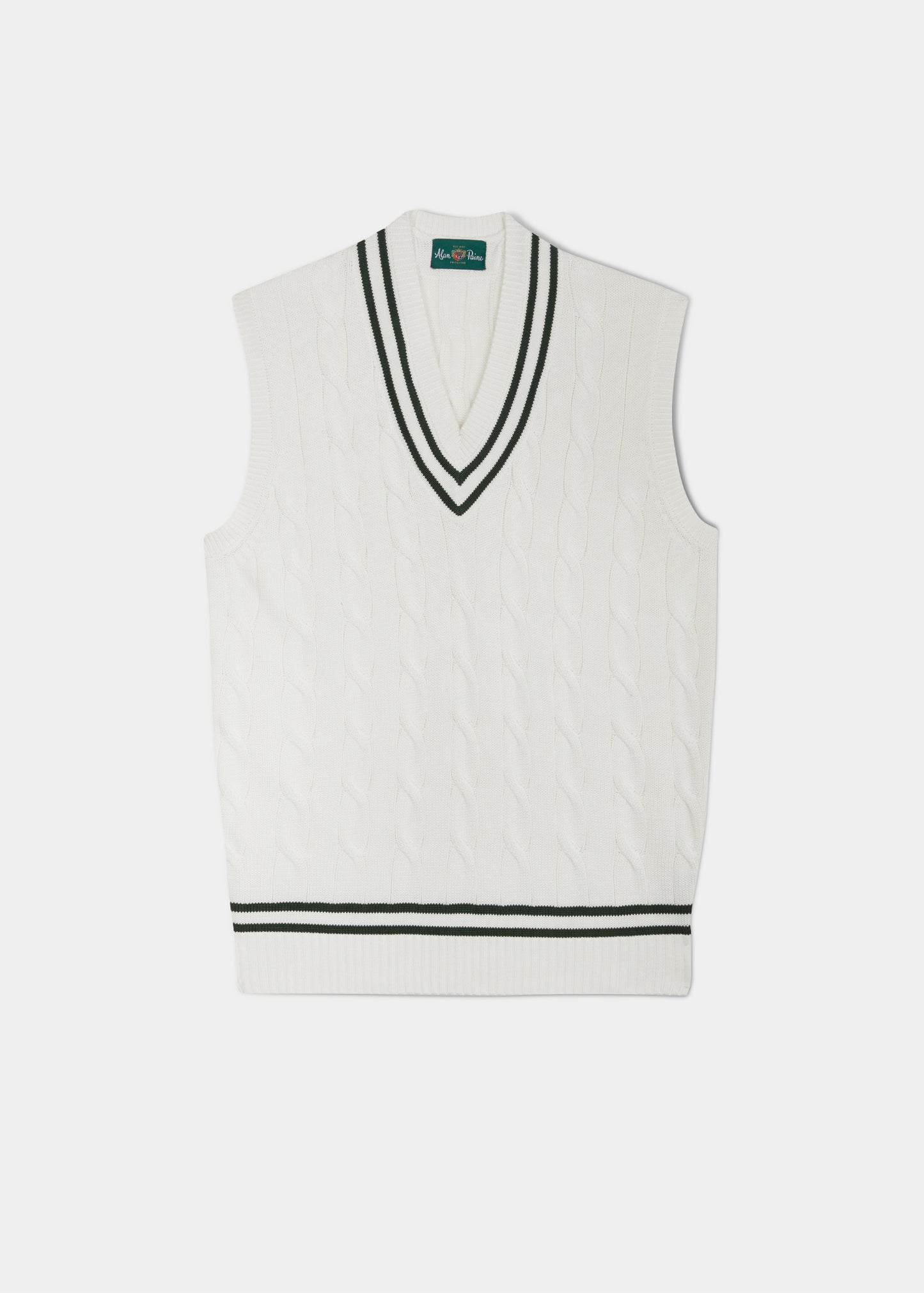 cable knit vee neck slipover in ecru with racing green trim.