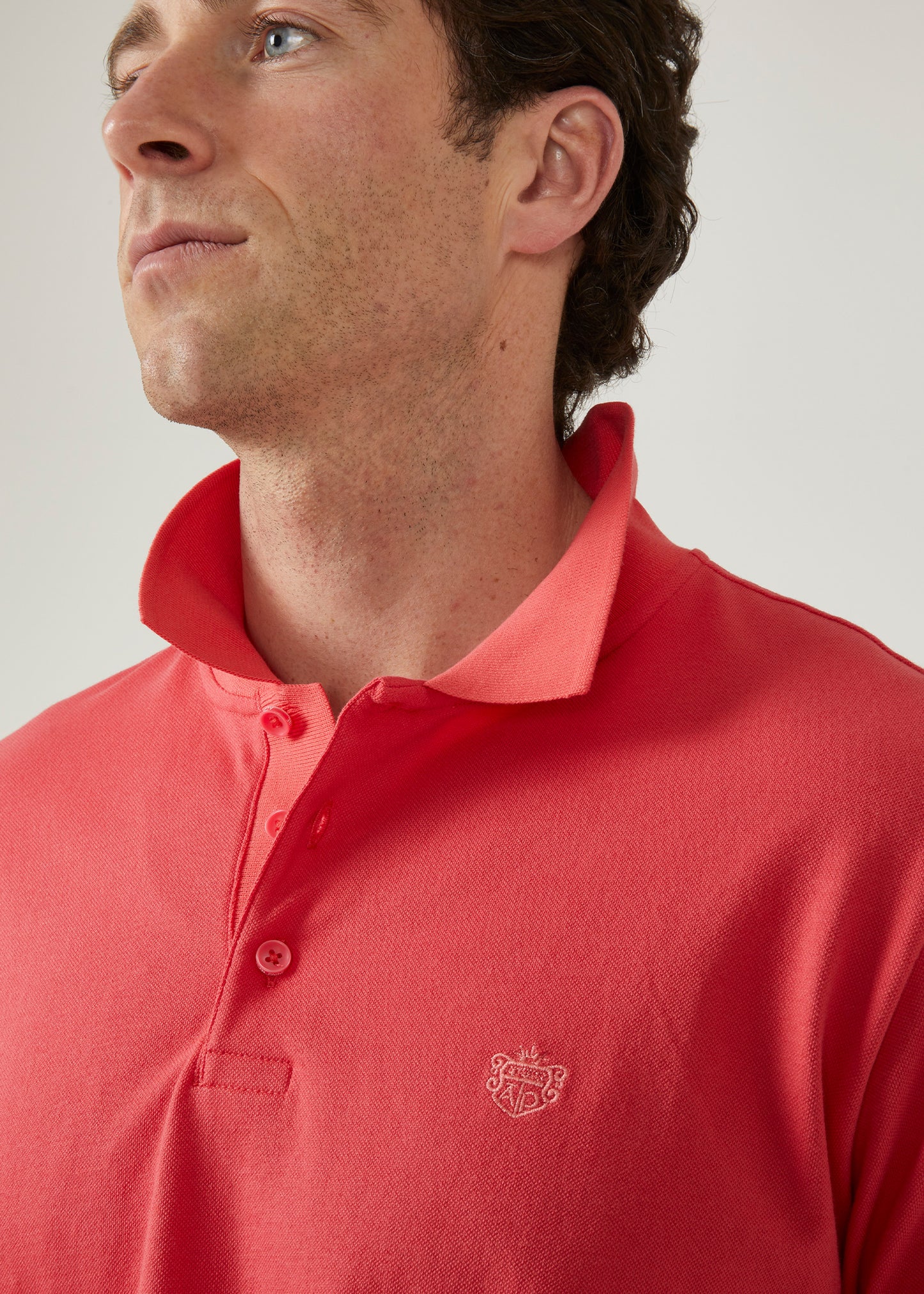 luxury pima cotton polo shirt with AP emblem in hibiscus pink.