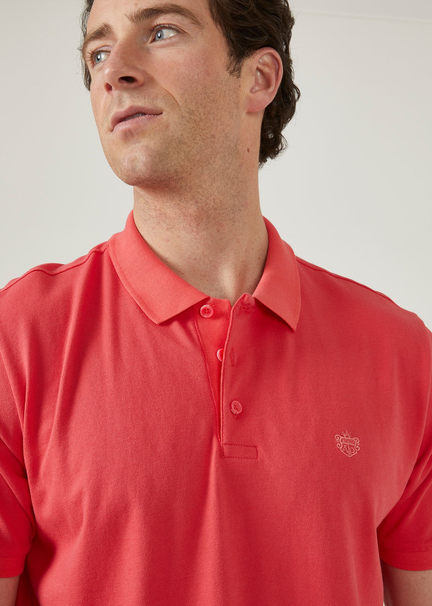luxury pima cotton polo shirt with AP emblem in hibiscus pink.