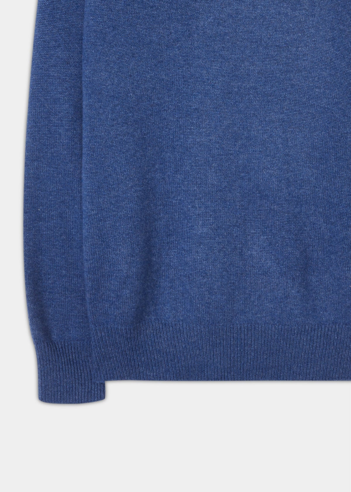 Close-up of the hem and sleeve cuff of a denim Selkirk Pure Cashmere V-Neck Jumper in a classic fit.