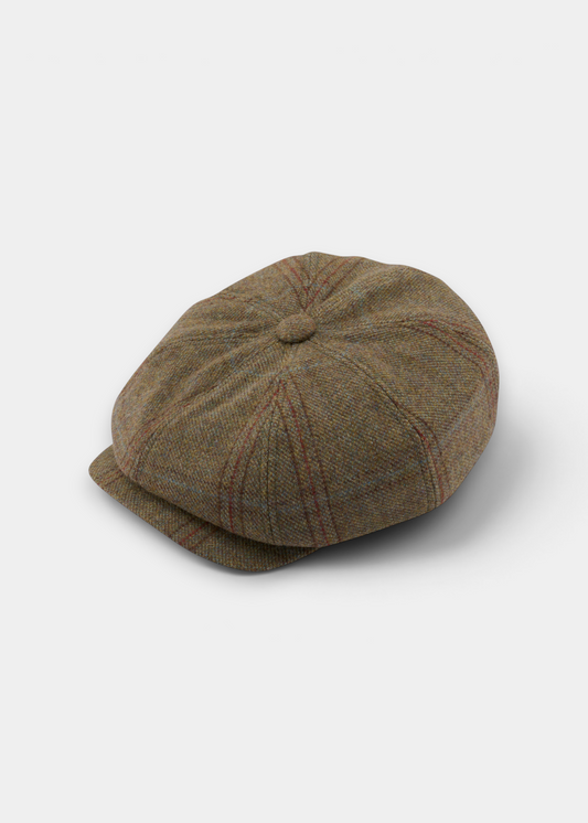 A brown tweed newsboy cap with subtle red and blue plaid lines, photographed on a clean light gray background.