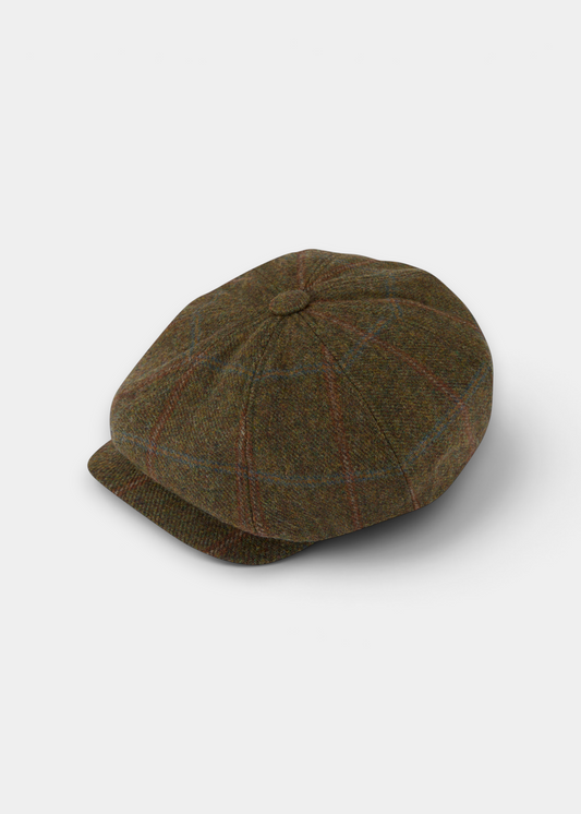 A brown tweed flat cap with a subtle red and blue windowpane plaid pattern, photographed on a light gray background.