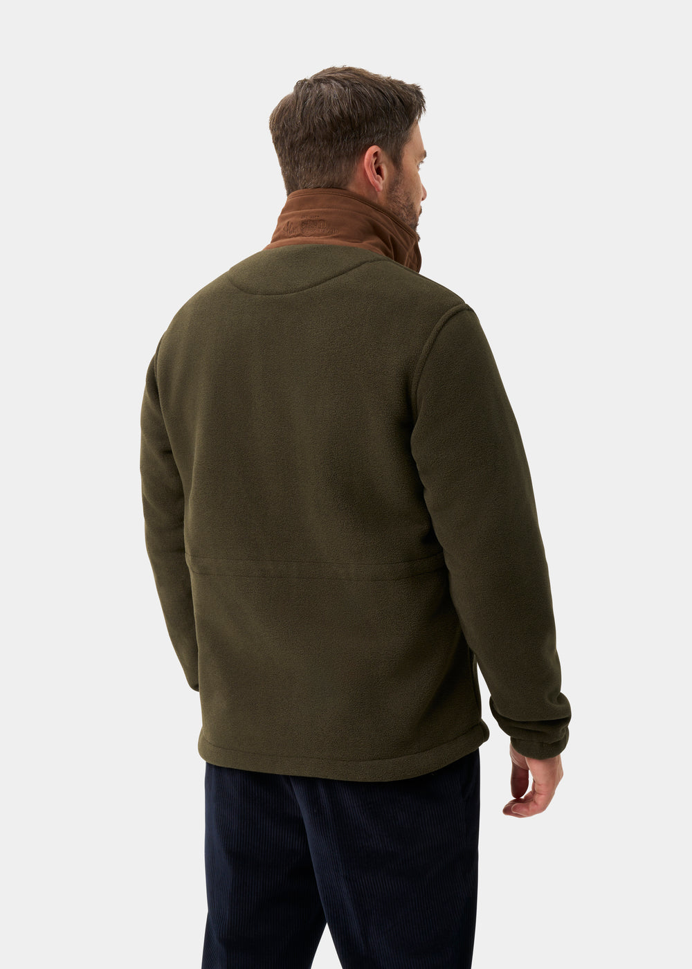 A man in an Aylsham Men’s Fleece Jacket in green stands with his back to the camera against a plain background.