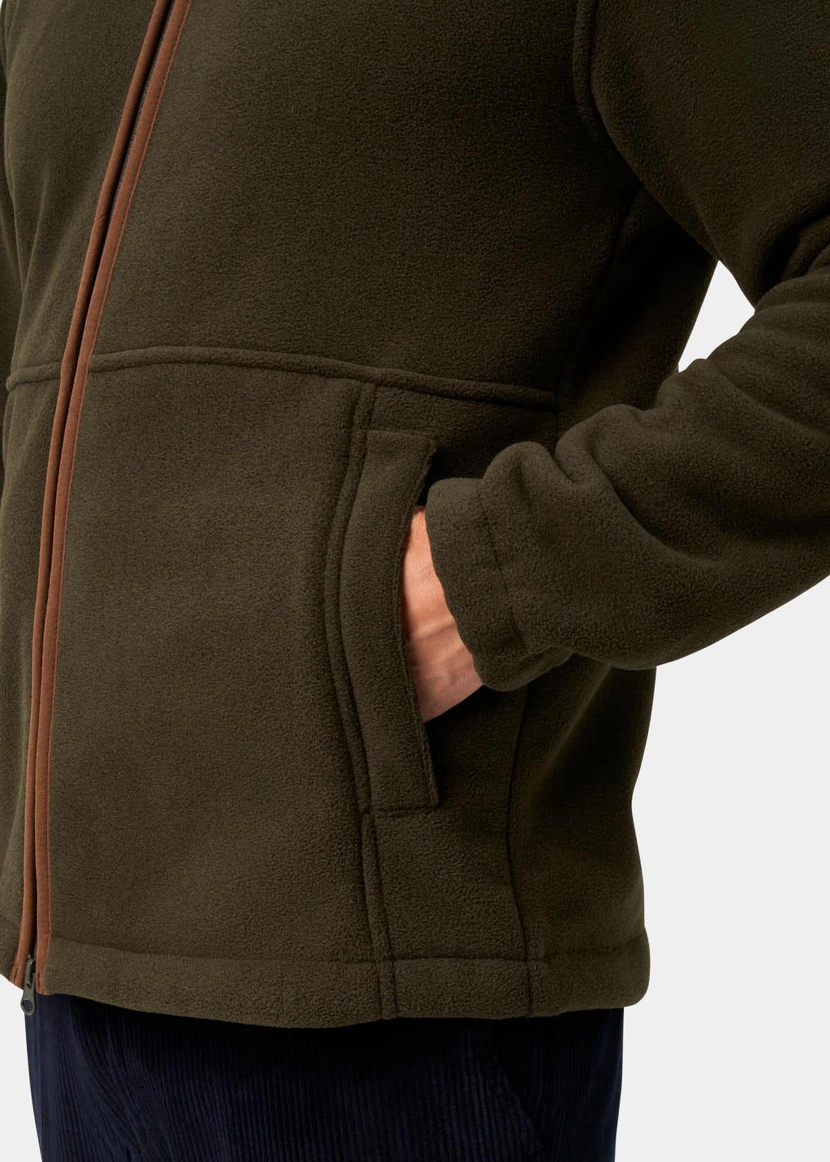 Man in green Aylsham Men’s Fleece Jacket, hand in pocket, brown zipper visible, on a white background.