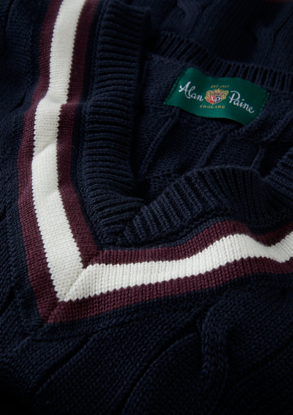Sandridge Cotton Cable Knit V-Neck Cricket Jumper in dark navy with white and maroon trim at the V-neck.