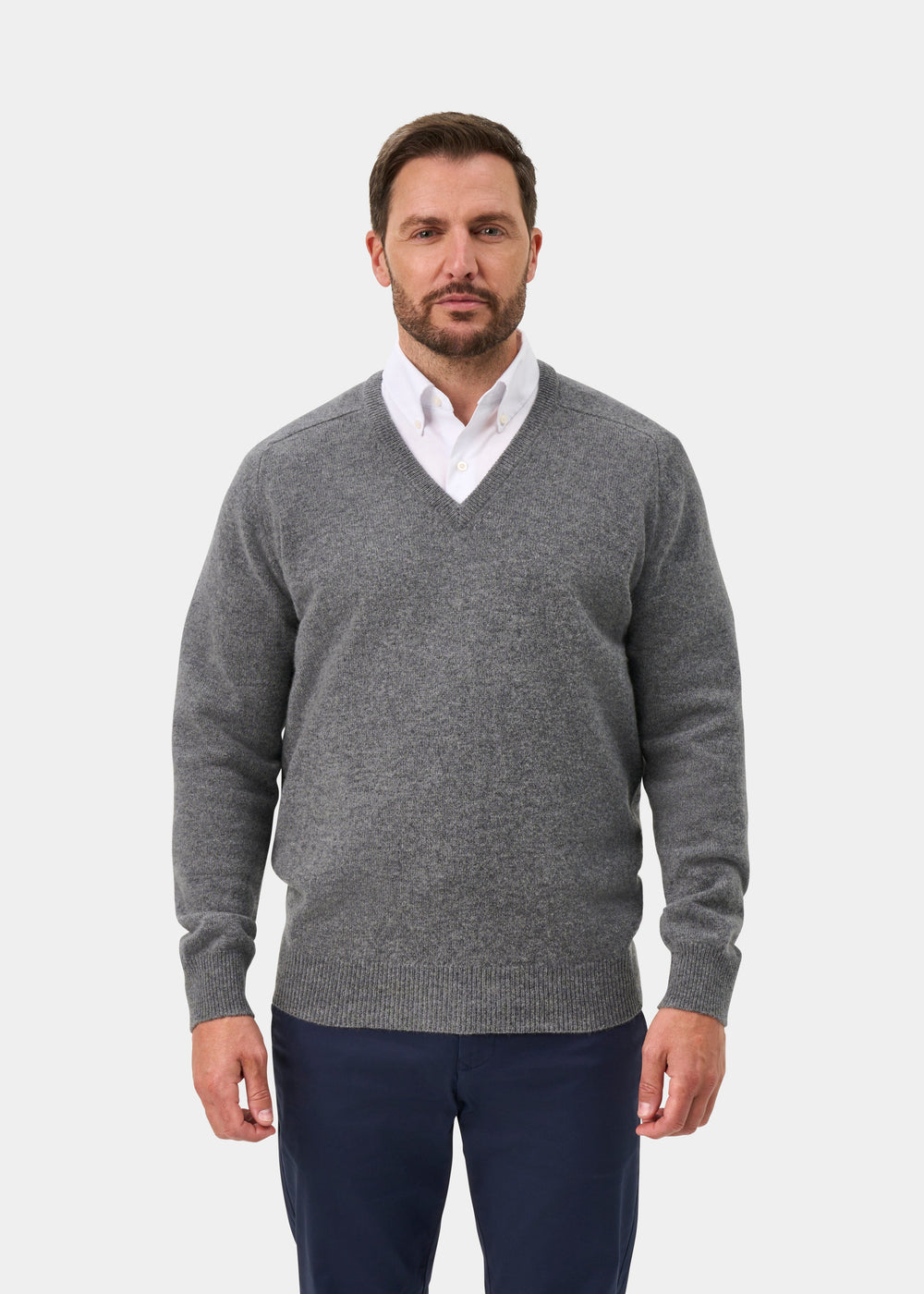 Man in Hampshire Lambswool V-Neck Jumper in Grey Mix, classic fit, over white shirt and navy pants.