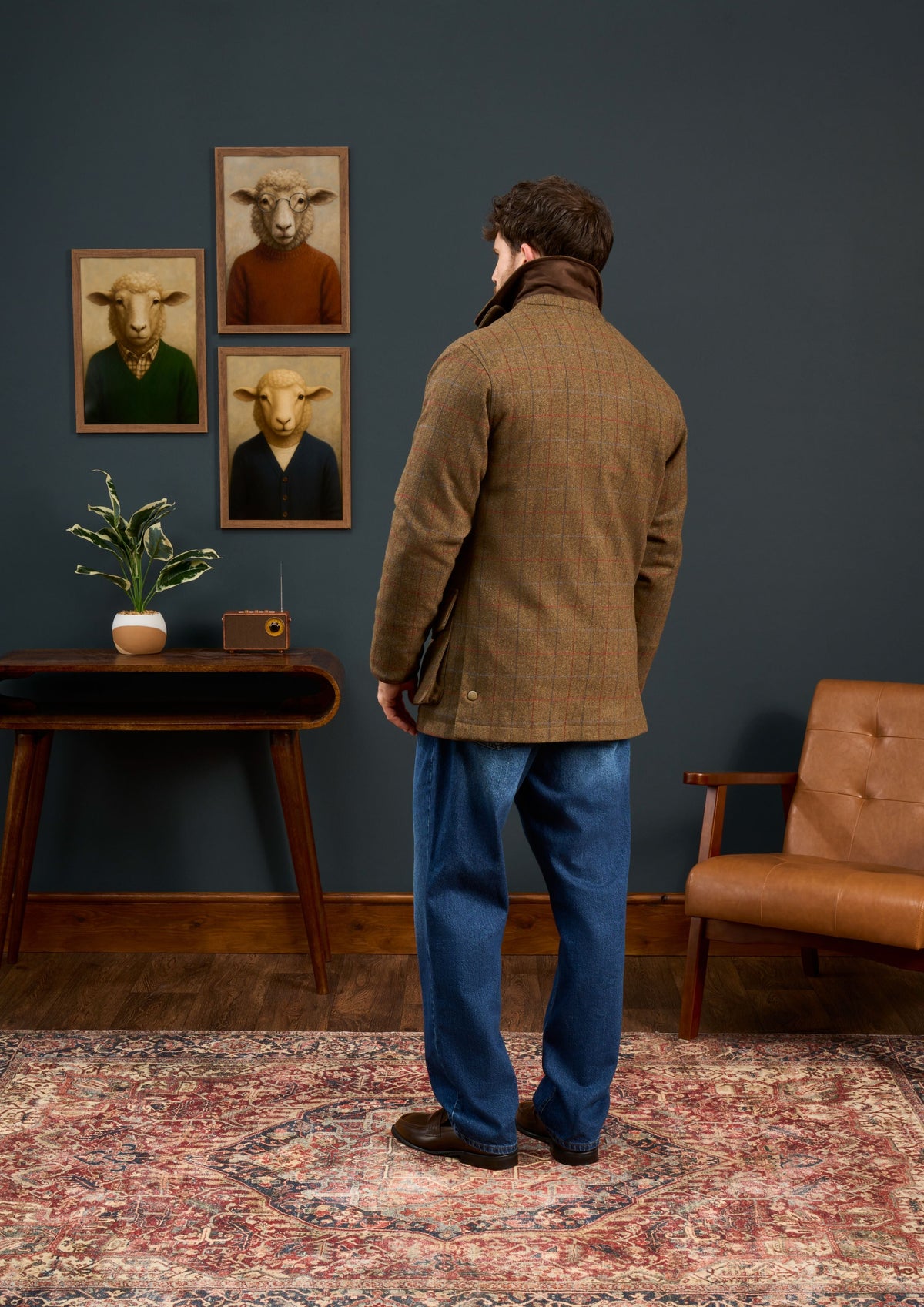 A man seen from behind wearing a brown Surrey Men’s Tweed Waterproof Coat in Hawkswood - Shooting Fit with a corduroy collar.