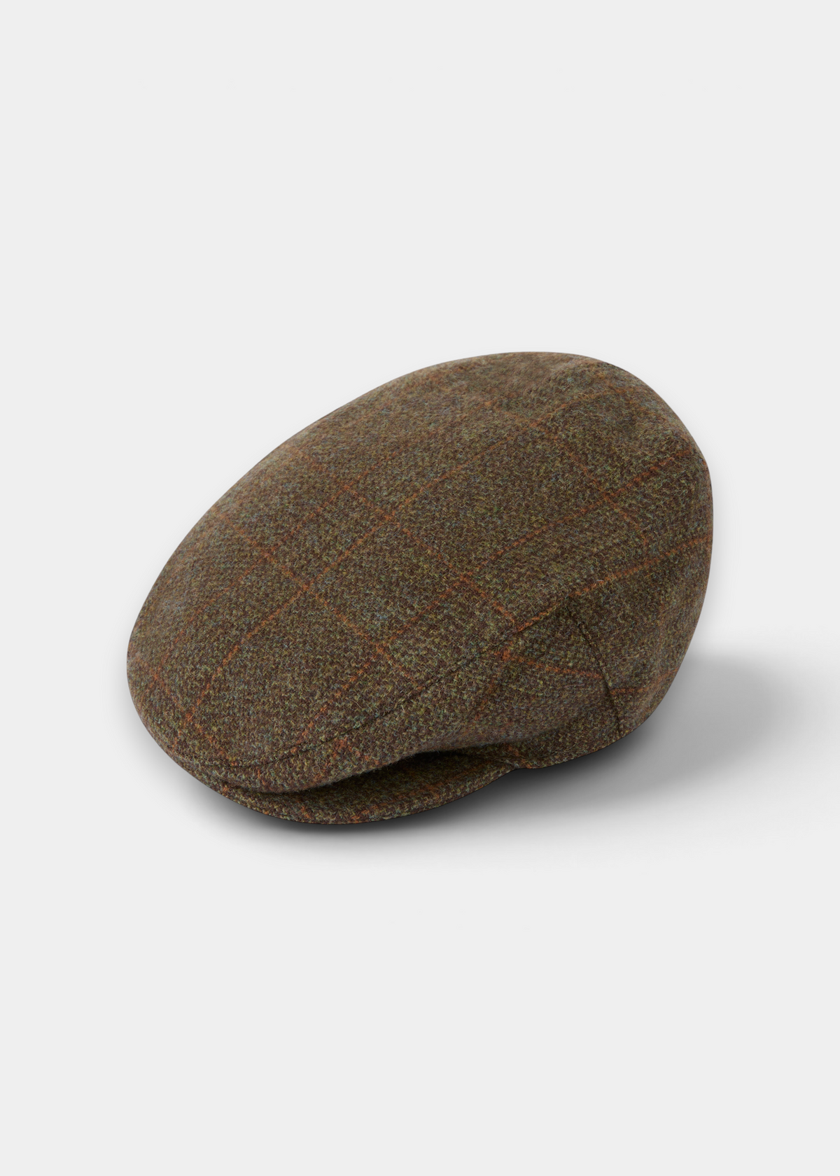 Surrey Men’s Tweed Waterproof Flat Cap in Field Maple, a brown wool flat cap featuring a subtle orange grid pattern.