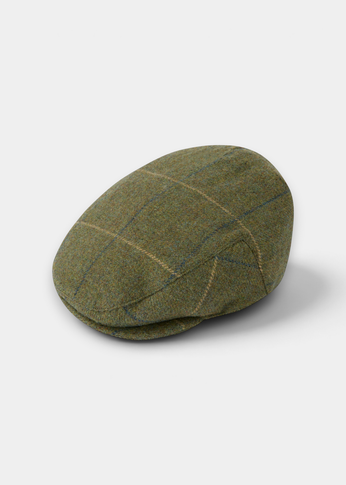 Surrey Men’s Tweed Waterproof Flat Cap in Lovat Blue, an olive green wool flat cap featuring a subtle blue and tan check.