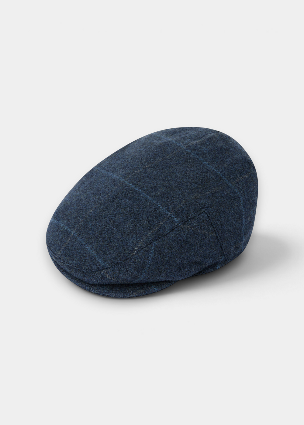 Surrey Men’s Tweed Waterproof Flat Cap in Midnight Blue: a dark blue waterproof tweed flat cap with a subtle plaid pattern.