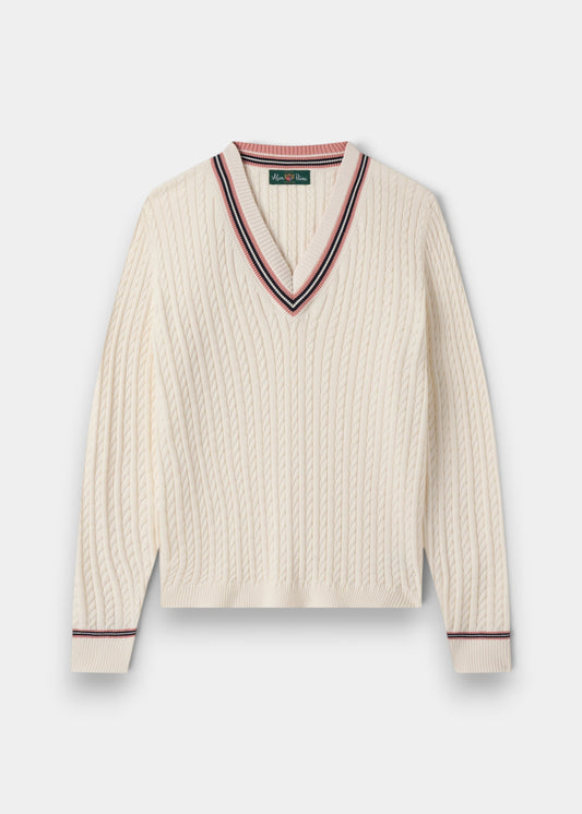 Alan Paine ladies ecru cable knit cricket jumper with v-neck, featuring dusk pink and dark navy striped trim.