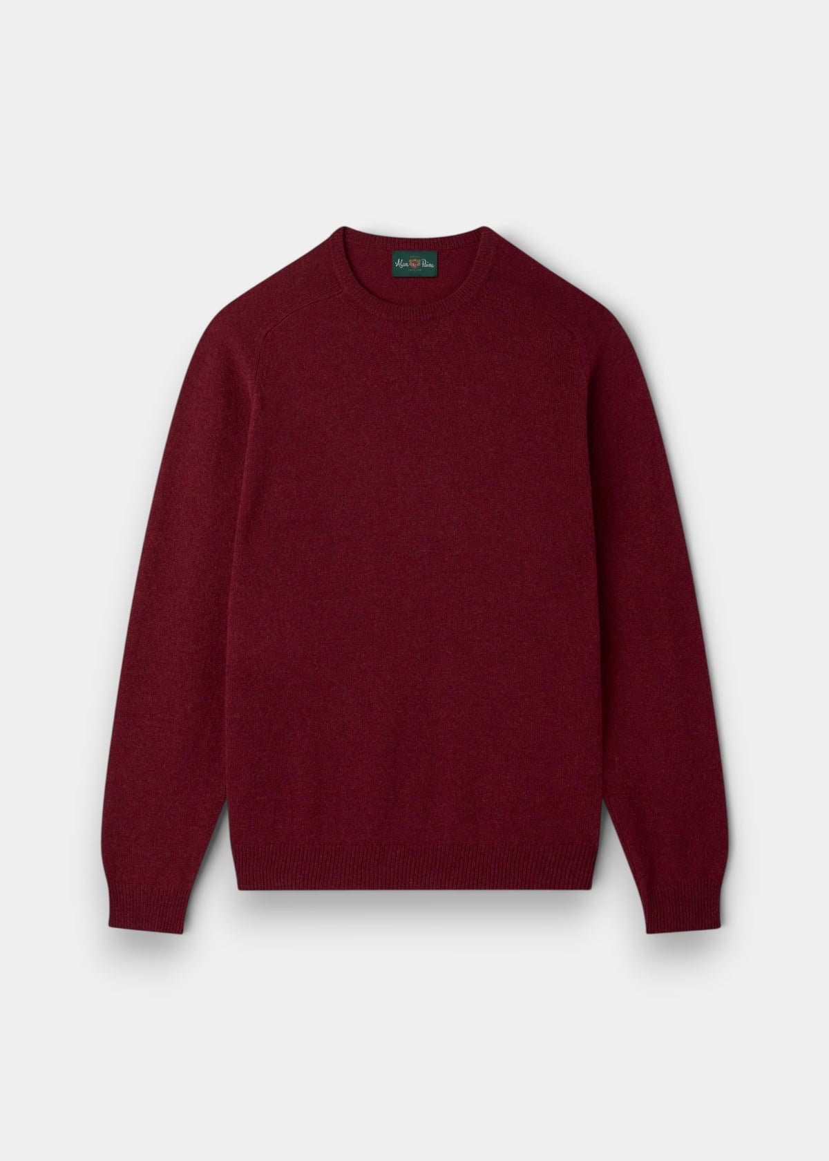 Lenzie Lambswool Crew Neck Jumper in Garnet, Regular Fit, long sleeves, laid flat on a light gray background.