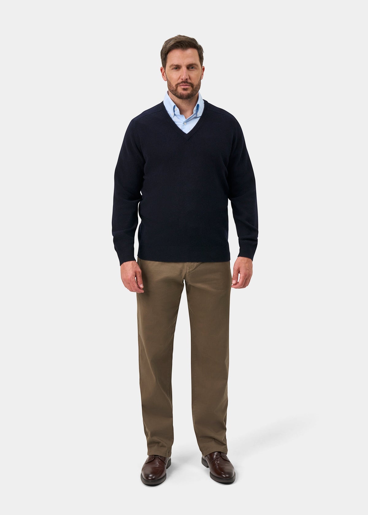 Alan Paine navy V-neck lambswool jumper worn by a man with a light blue shirt and brown trousers
