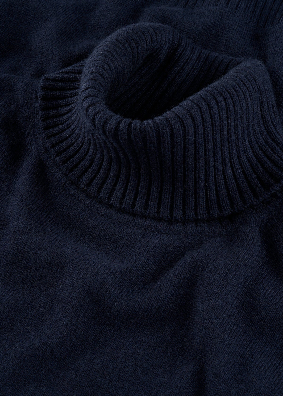 Close-up of Alexa Wool & Cashmere Roll Neck Jumper in Dark Navy, ribbed collar detail, laid flat.