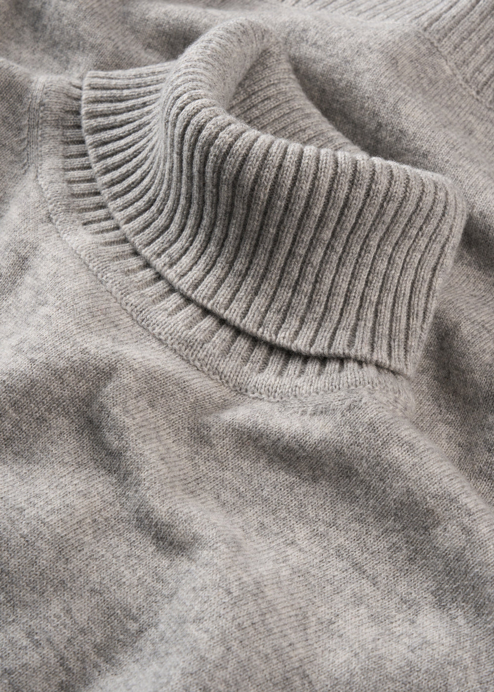 Close-up of the Alexa Wool & Cashmere Roll Neck Jumper in Husky, featuring a ribbed collar and laid flat.