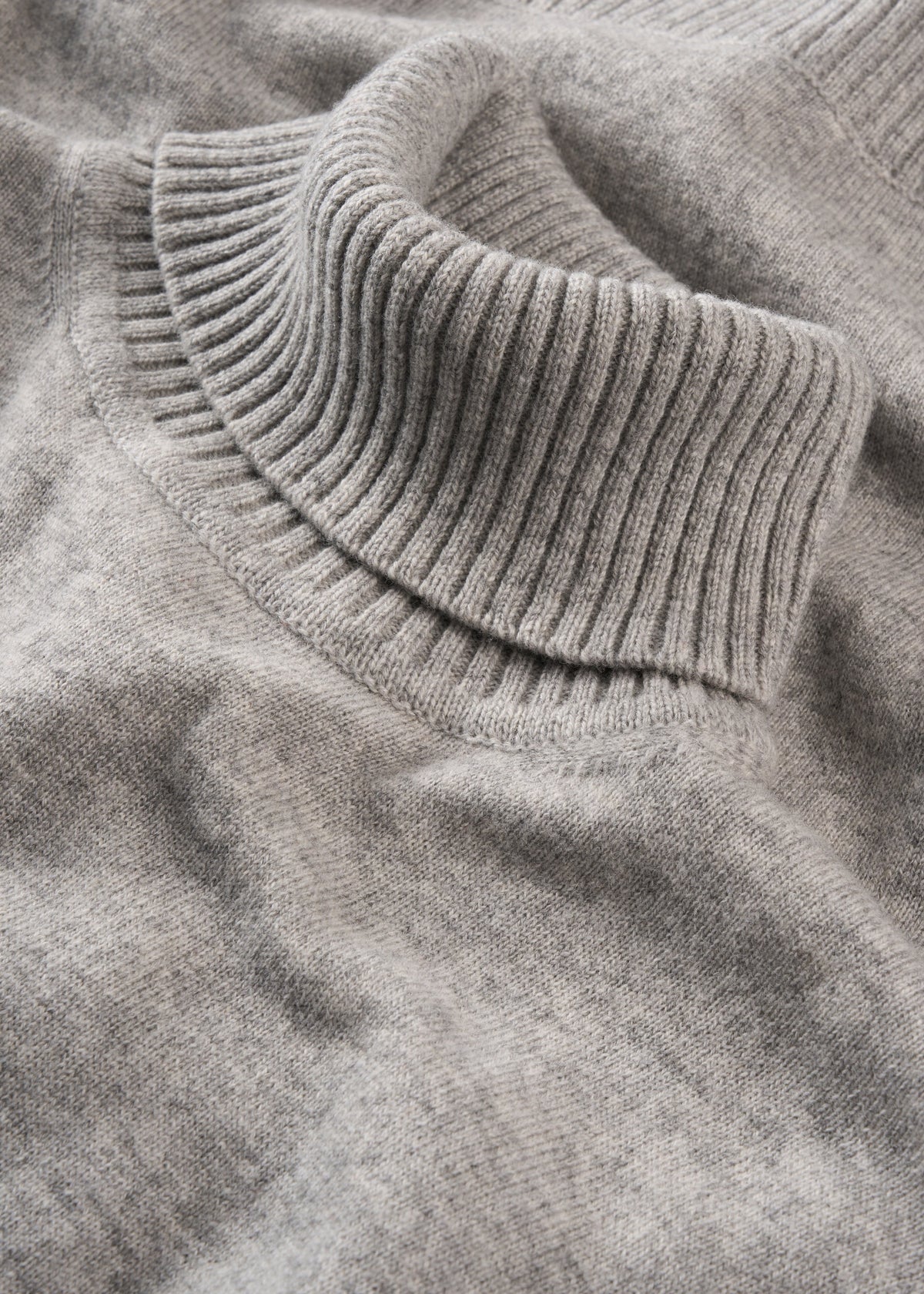 Close-up of the Alexa Wool & Cashmere Roll Neck Jumper in Husky, featuring a ribbed collar and laid flat.