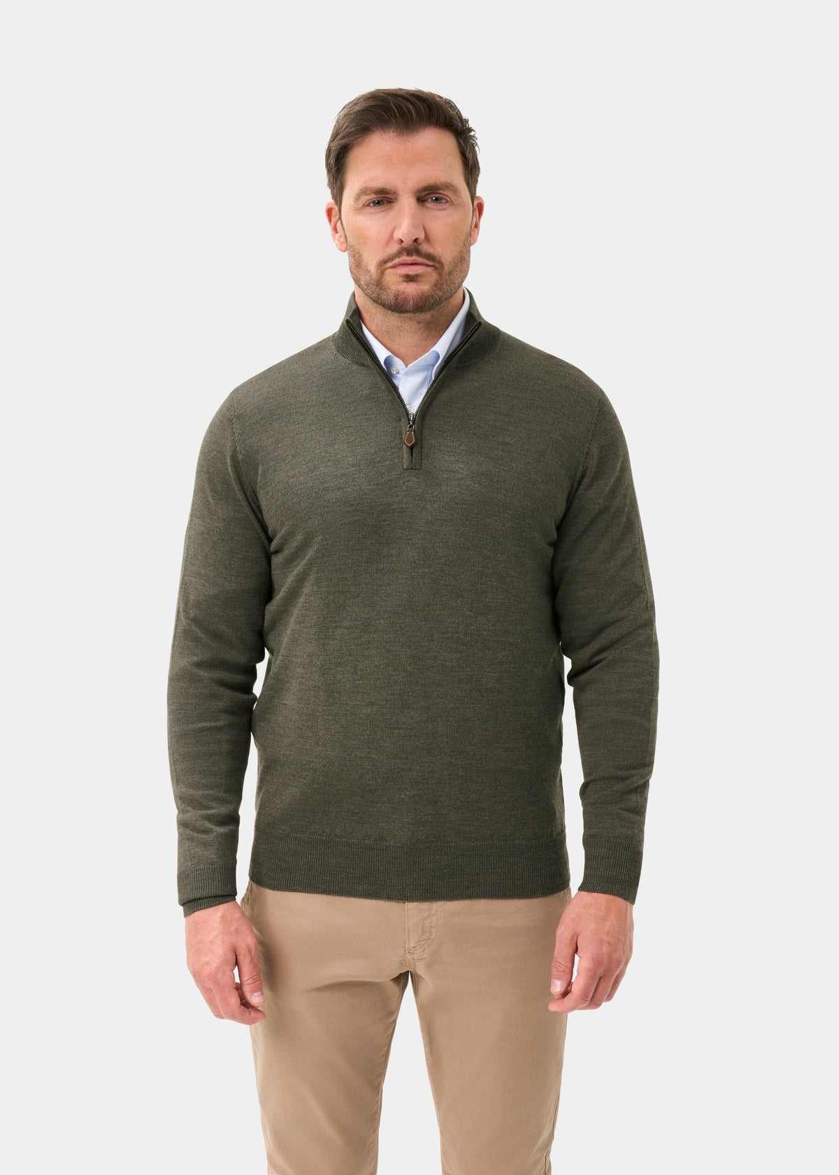 Man in a seaweed Barton Merino Wool Quarter Zip Jumper and khaki pants standing against a plain white background.