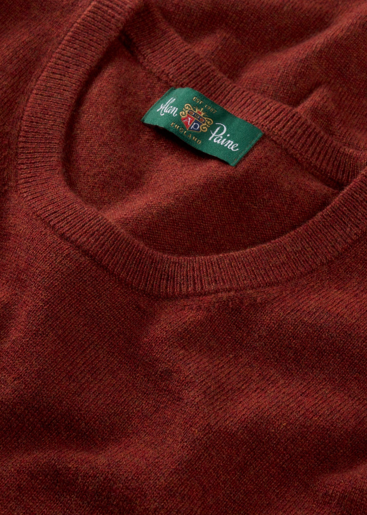 Close-up of the Ivy Wool & Cashmere Crew Neck Jumper in Autumn, a perfect ladies’ knit with a green neckline label.
