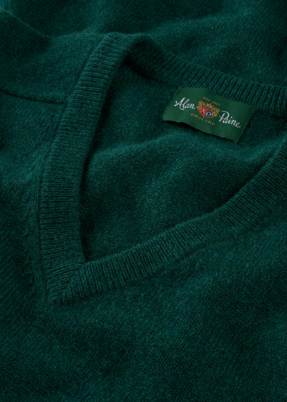 Close-up of Kilsyth Lambswool V-Neck Jumper in Mallard, regular fit, with Alan Paine label on inside collar.