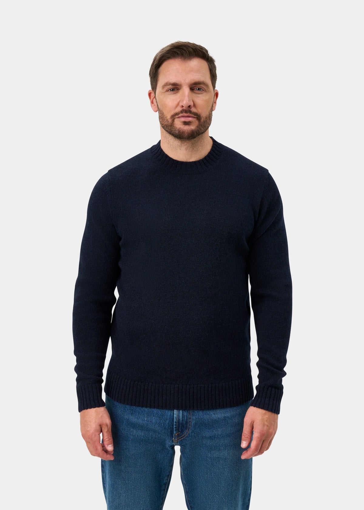 Man with short hair and beard in Kinnadie Supersoft Shetland Wool Crew Neck Jumper (Concord), regular fit, blue jeans.