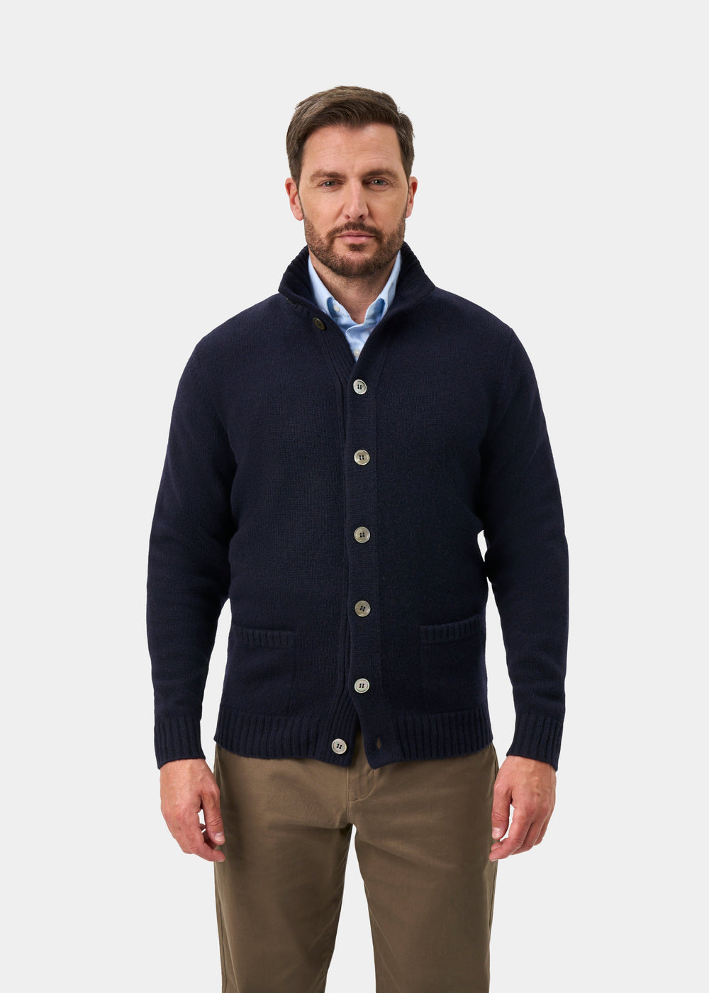 Man in a navy Landford Lambswool Mock Neck Jumper, light blue shirt, and khaki pants against a white background.
