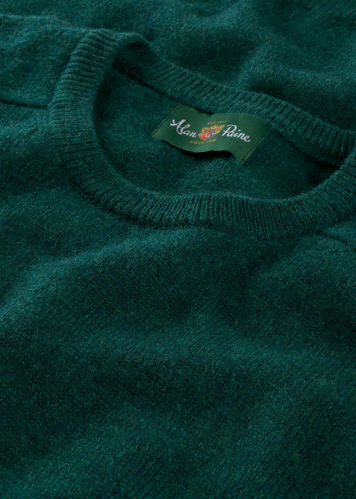 A close-up of the Lenzie Lambswool Crew Neck Jumper in Mallard, highlighting the crew neck and woven texture.