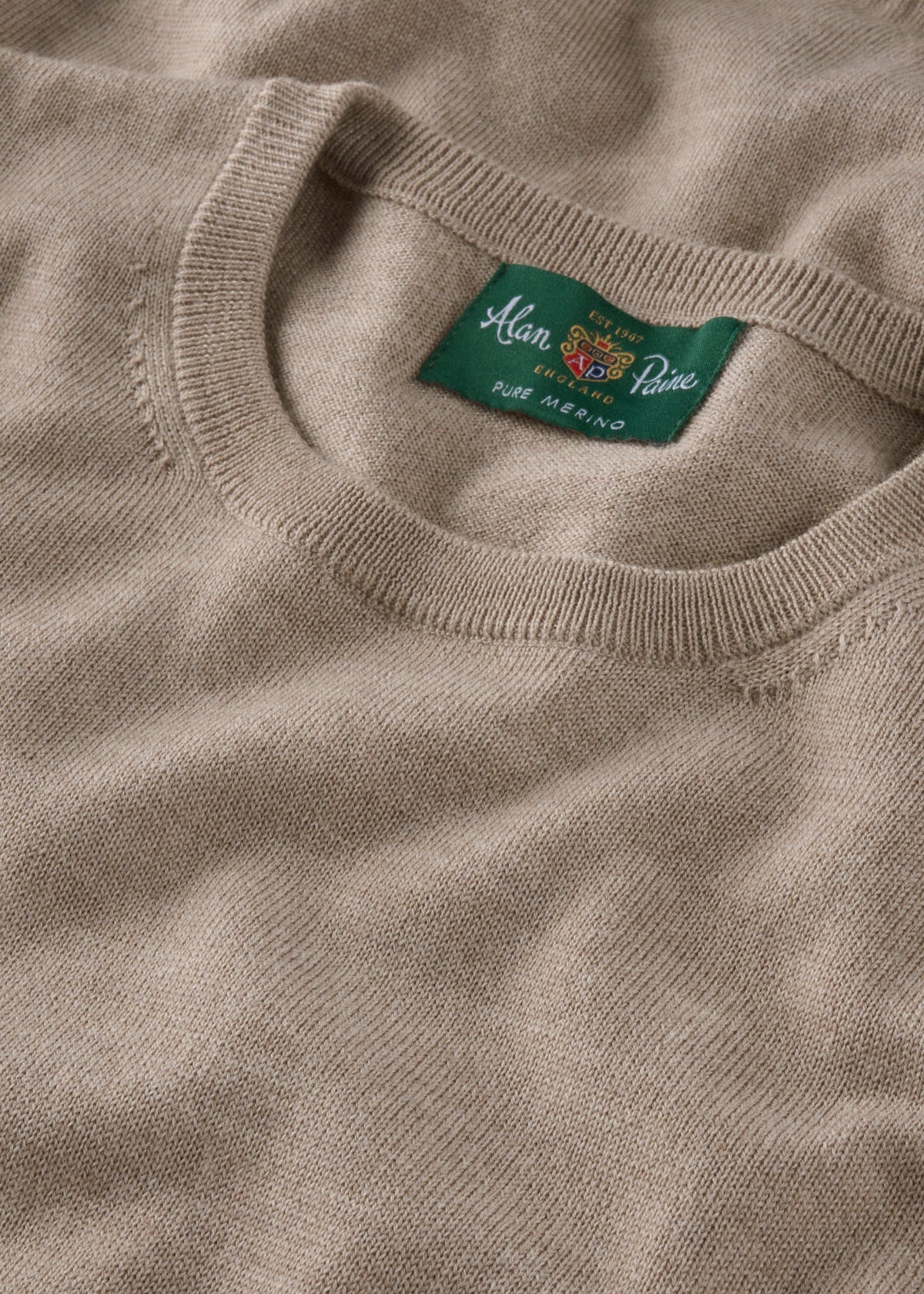 Radstone Merino Wool Crew Neck Jumper In Cobble featuring a green brand label at the collar.