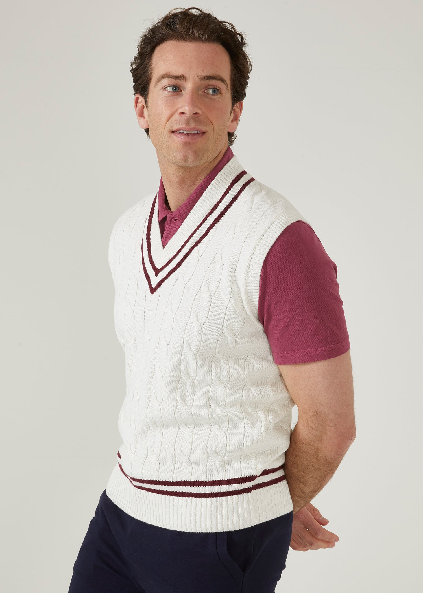 Ecru men's cable knit slipover in ecru with a claret trim.