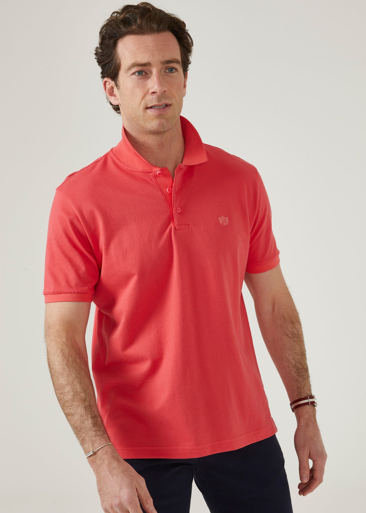 luxury pima cotton polo shirt with AP emblem in hibiscus pink.