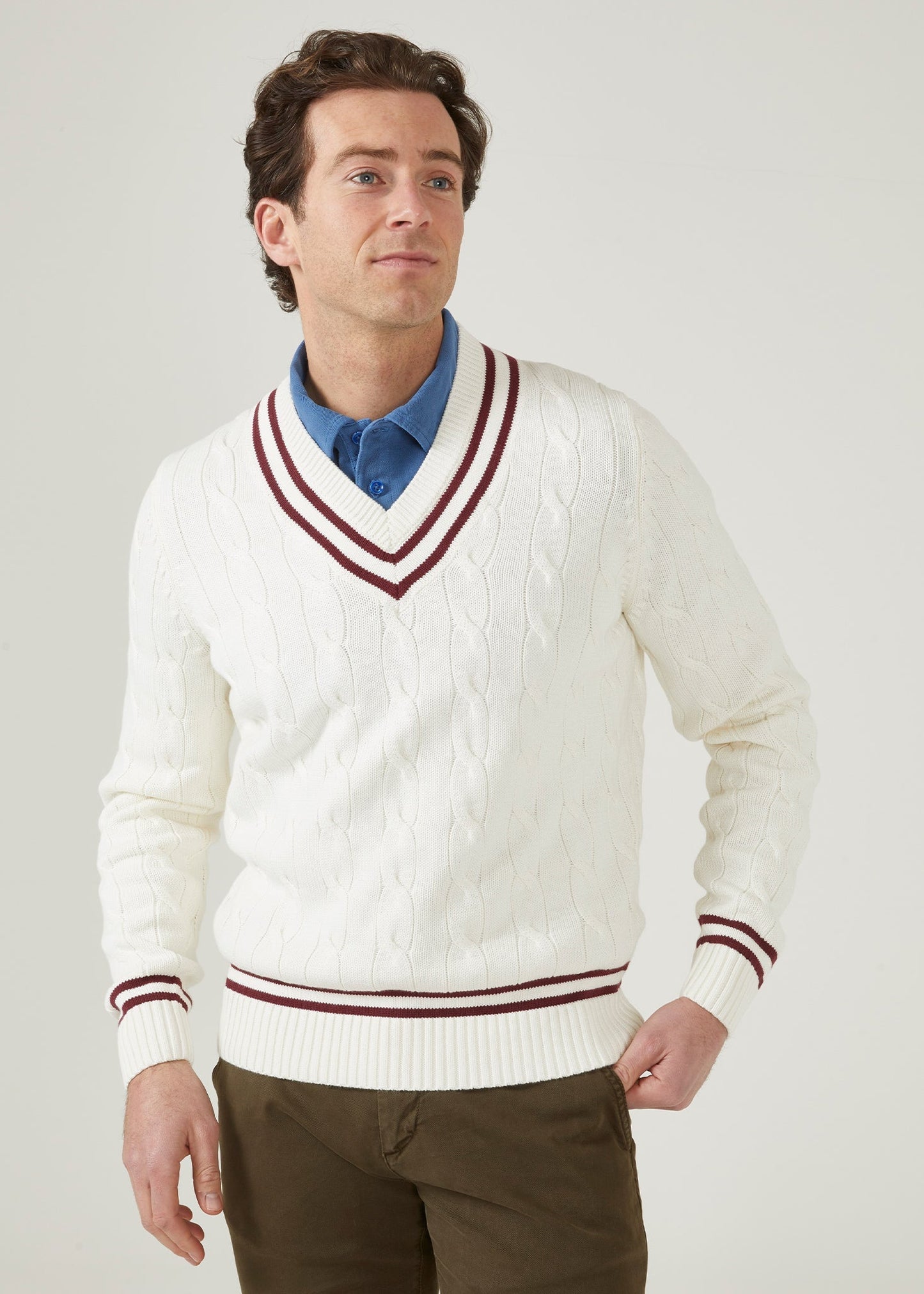 Ecru cricket jumper with a claret red trim and cable knit design.