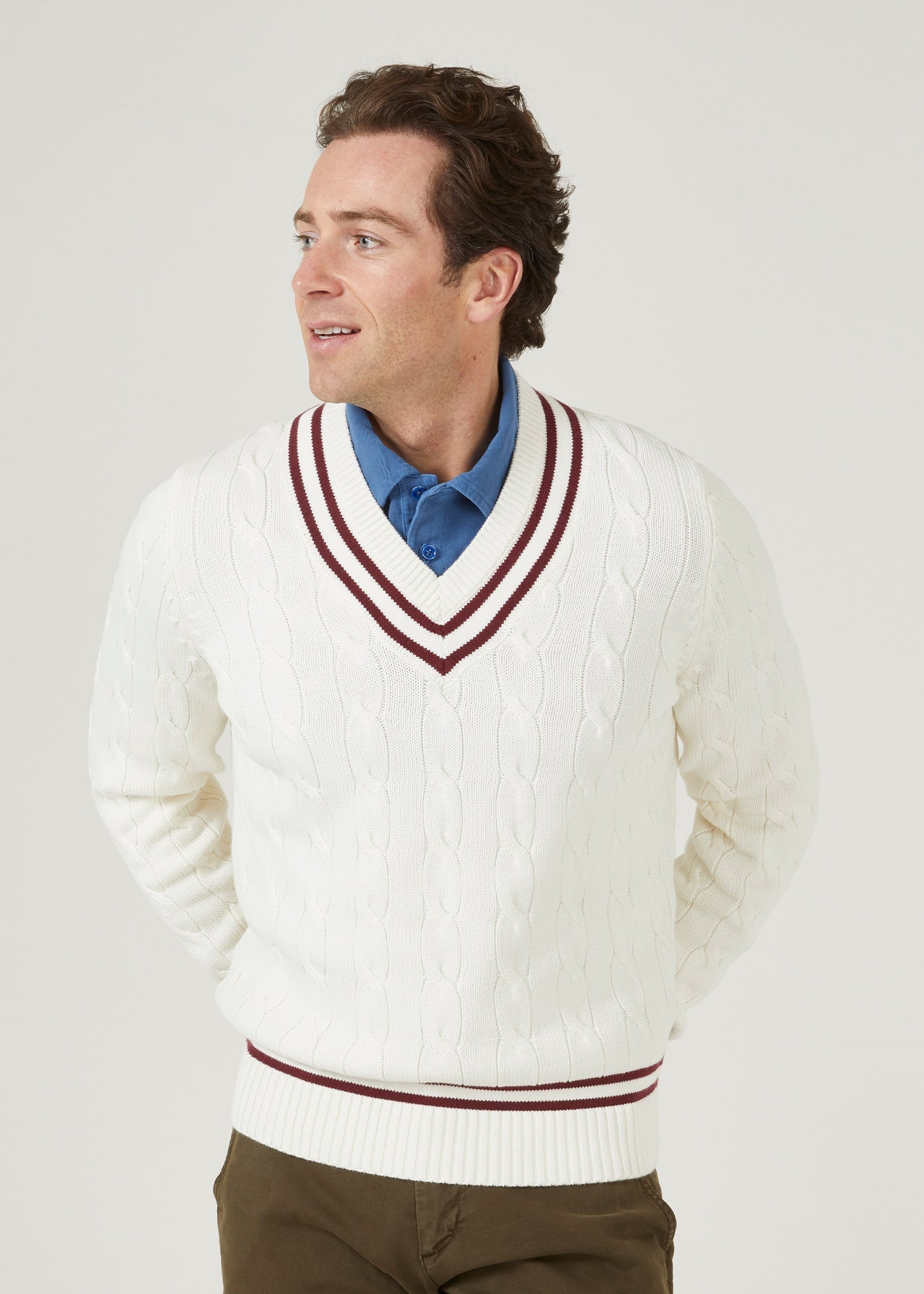 Ecru cricket jumper with a claret red trim and cable knit design.